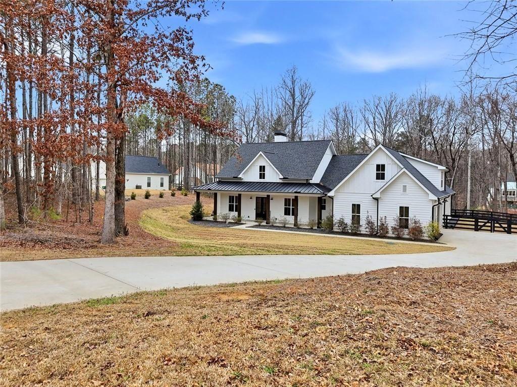 877 Arnold Mill Road Woodstock, GA 30188 - Photo 57 of 62 a front view of a house with a yard and trees