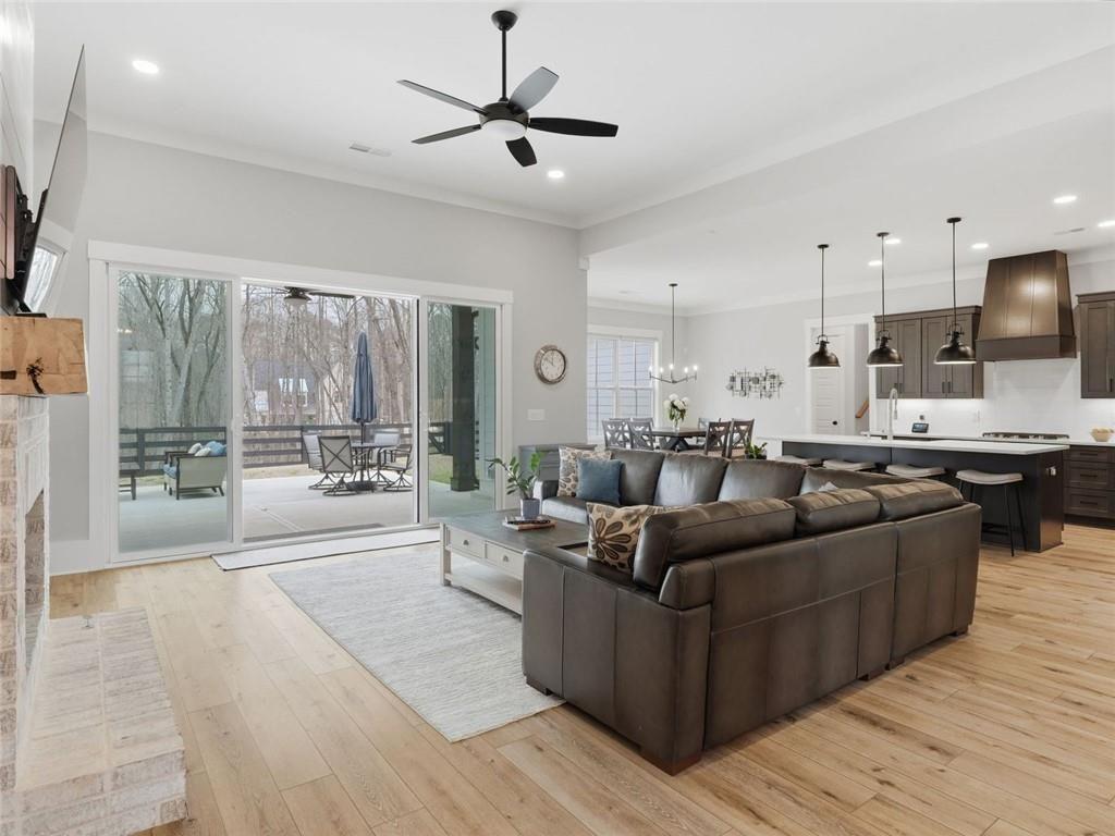 877 Arnold Mill Road Woodstock, GA 30188 - Photo 7 of 62 a living room with furniture a ceiling fan and a rug