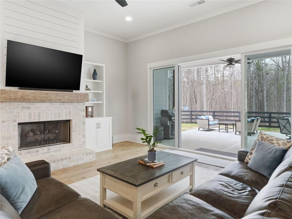 877 Arnold Mill Road Woodstock, GA 30188 - Photo 8 of 62 a living room with furniture a flat screen tv and a fireplace
