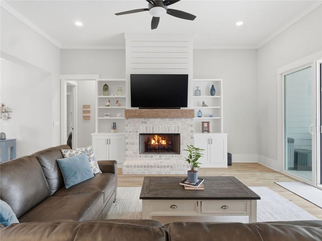 877 Arnold Mill Road Woodstock, GA 30188 - Photo 9 of 62 a living room with furniture a flat screen tv and a fireplace