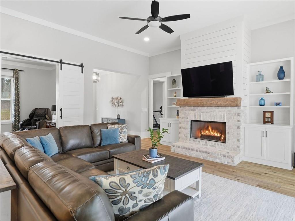 877 Arnold Mill Road Woodstock, GA 30188 - Photo 10 of 62 a living room with furniture a flat screen tv and a fireplace