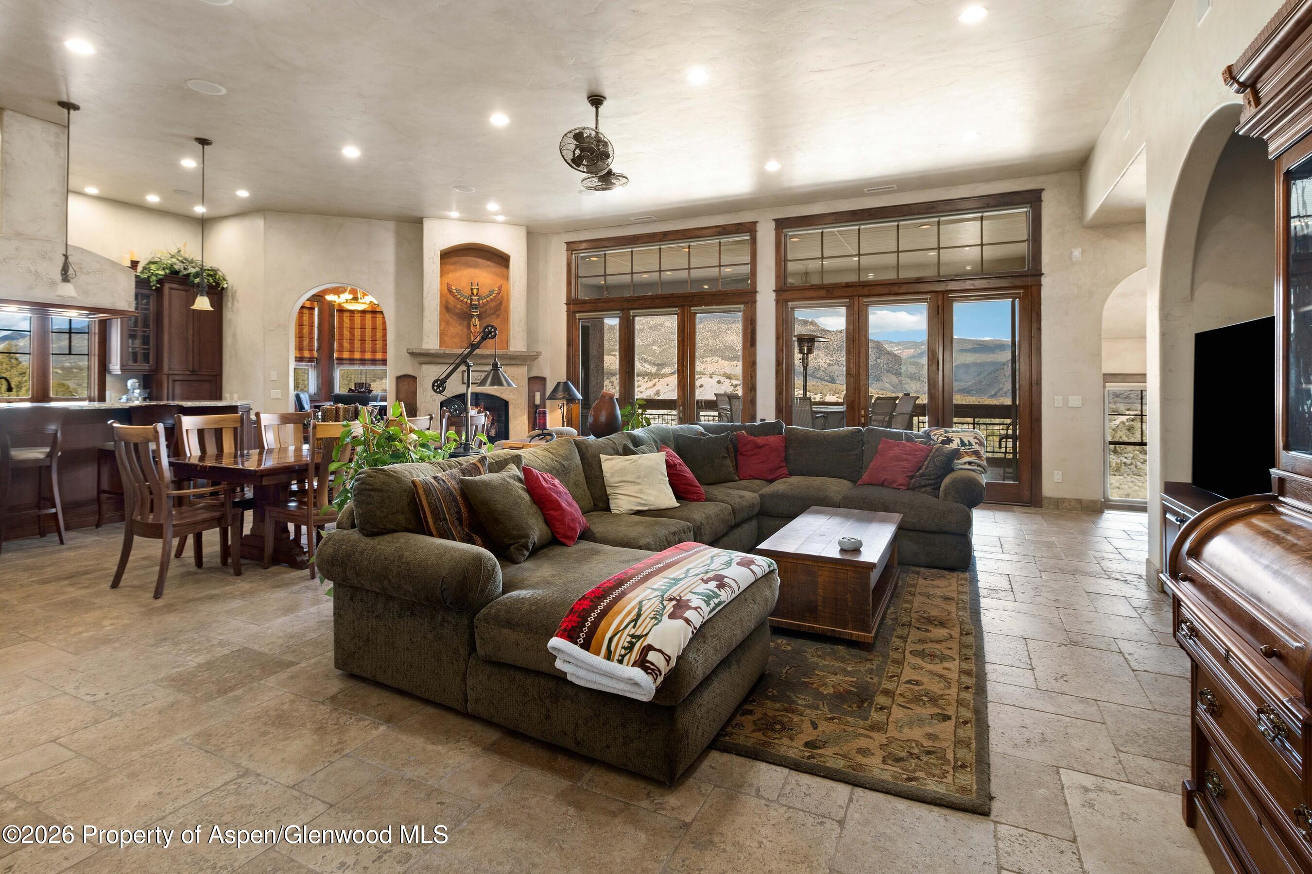 966 Mesa Drive Rifle, CO 81650 - Photo 11 of 54 a living room with furniture kitchen view and a large window