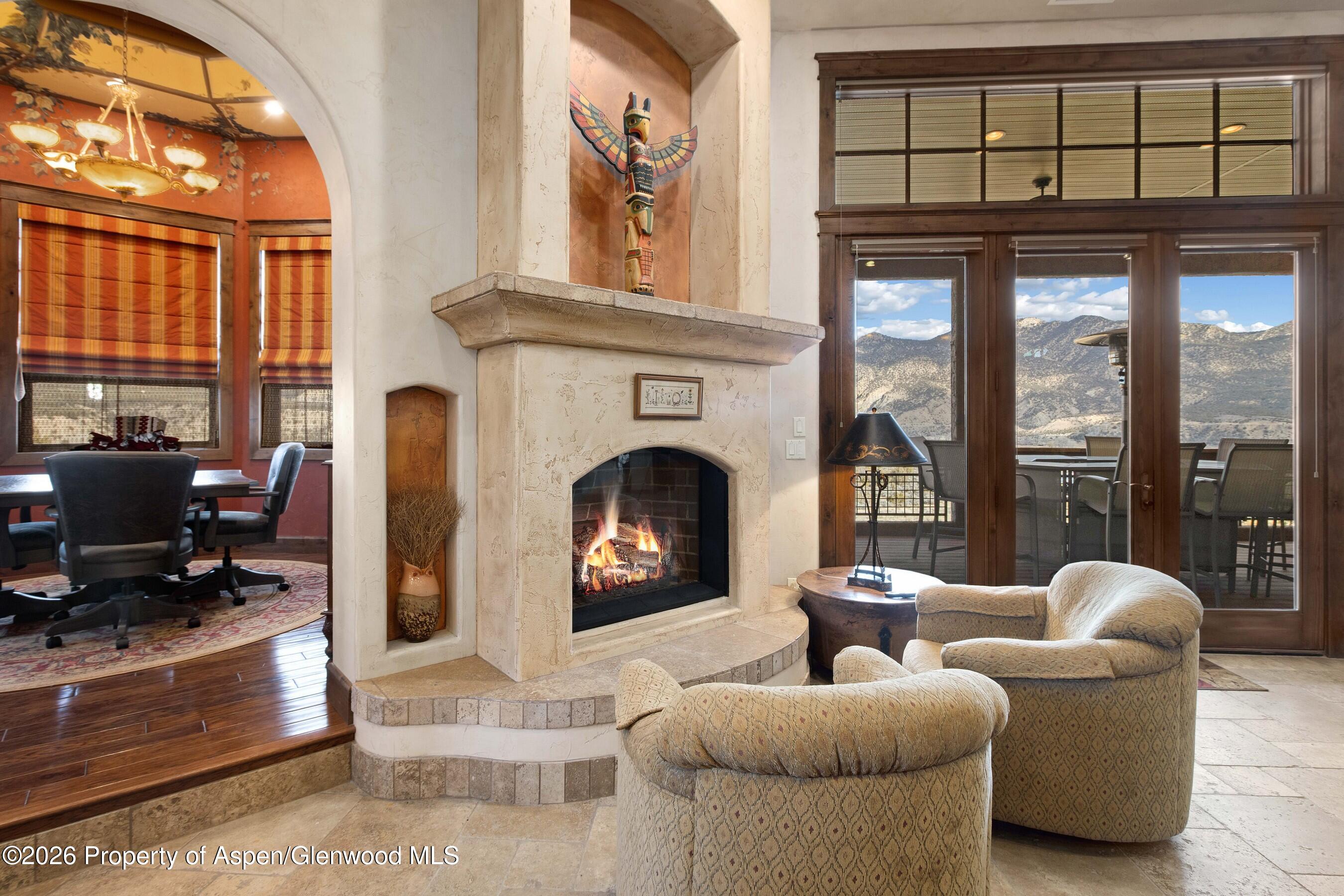 966 Mesa Drive Rifle, CO 81650 - Photo 14 of 54 a living room with furniture a fireplace and a large window