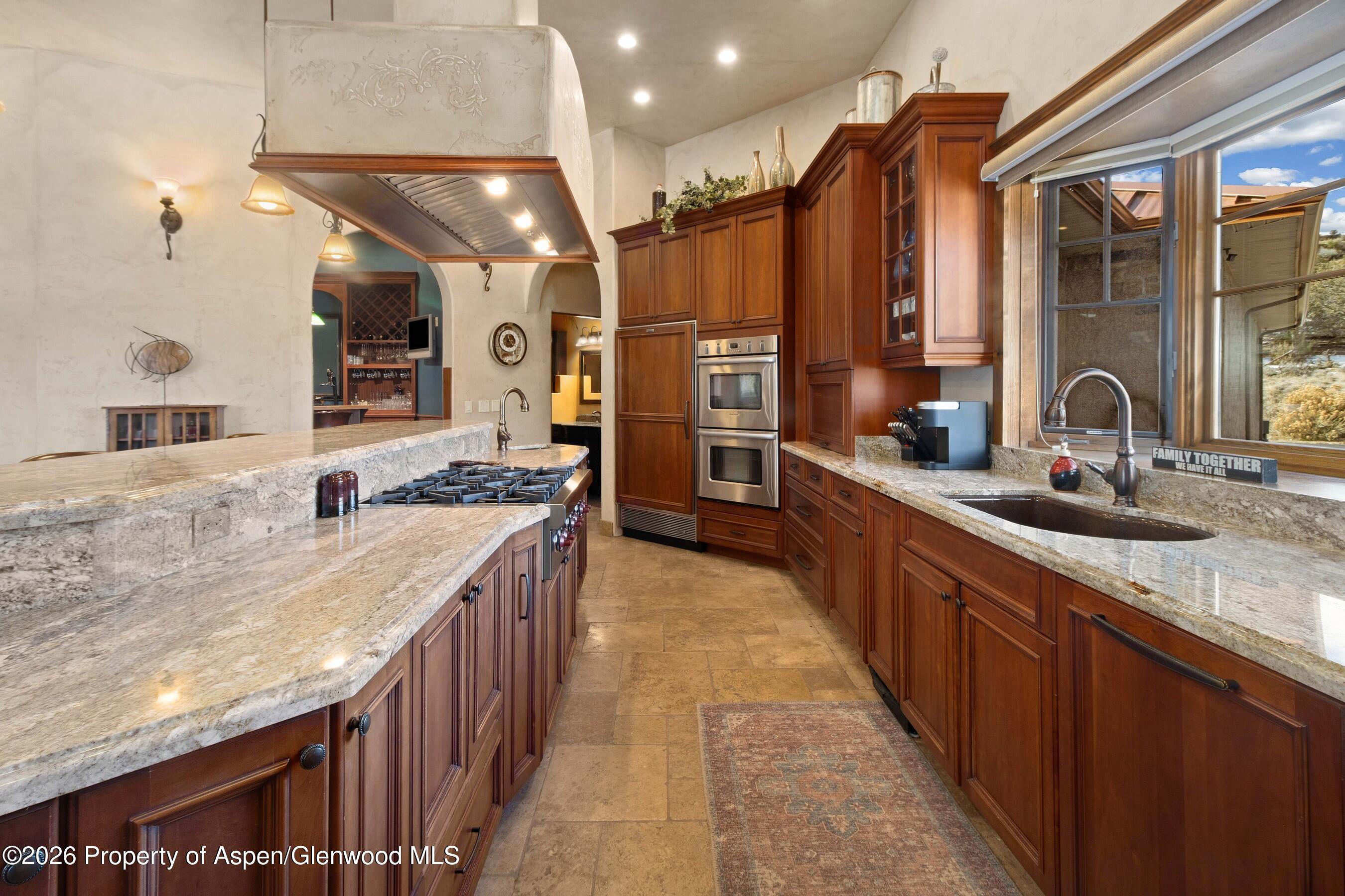 966 Mesa Drive Rifle, CO 81650 - Photo 17 of 54 a large kitchen with a large counter top a sink a stove and a refrigerator