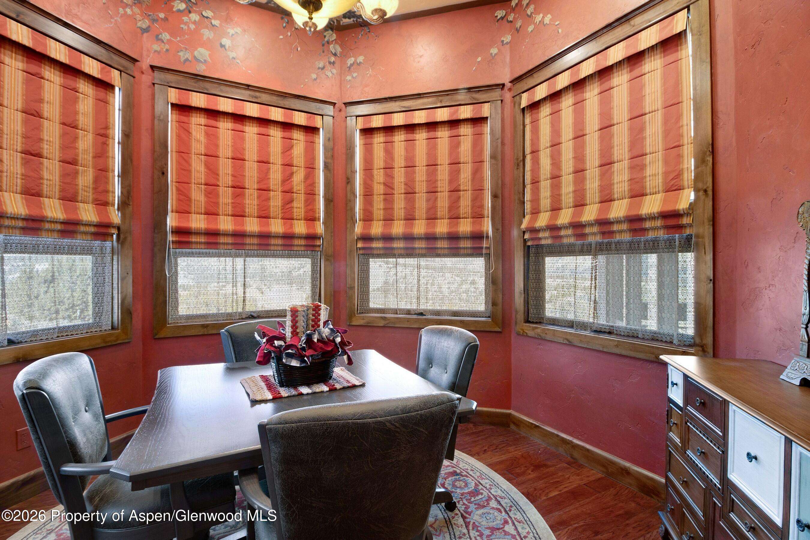966 Mesa Drive Rifle, CO 81650 - Photo 20 of 54 a view of a dining room with furniture a chandelier and wooden floor
