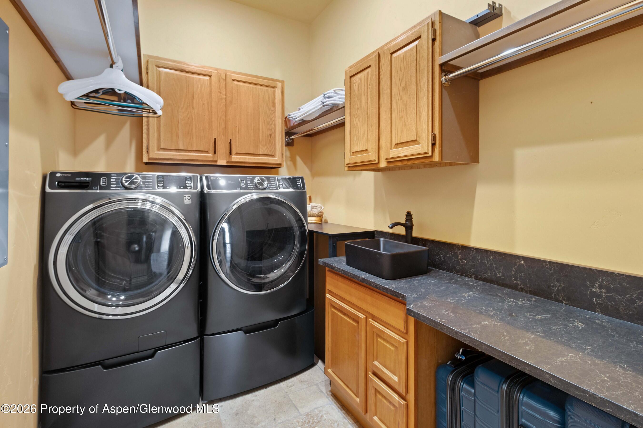 966 Mesa Drive Rifle, CO 81650 - Photo 26 of 54 a kitchen with a sink a stove and cabinets