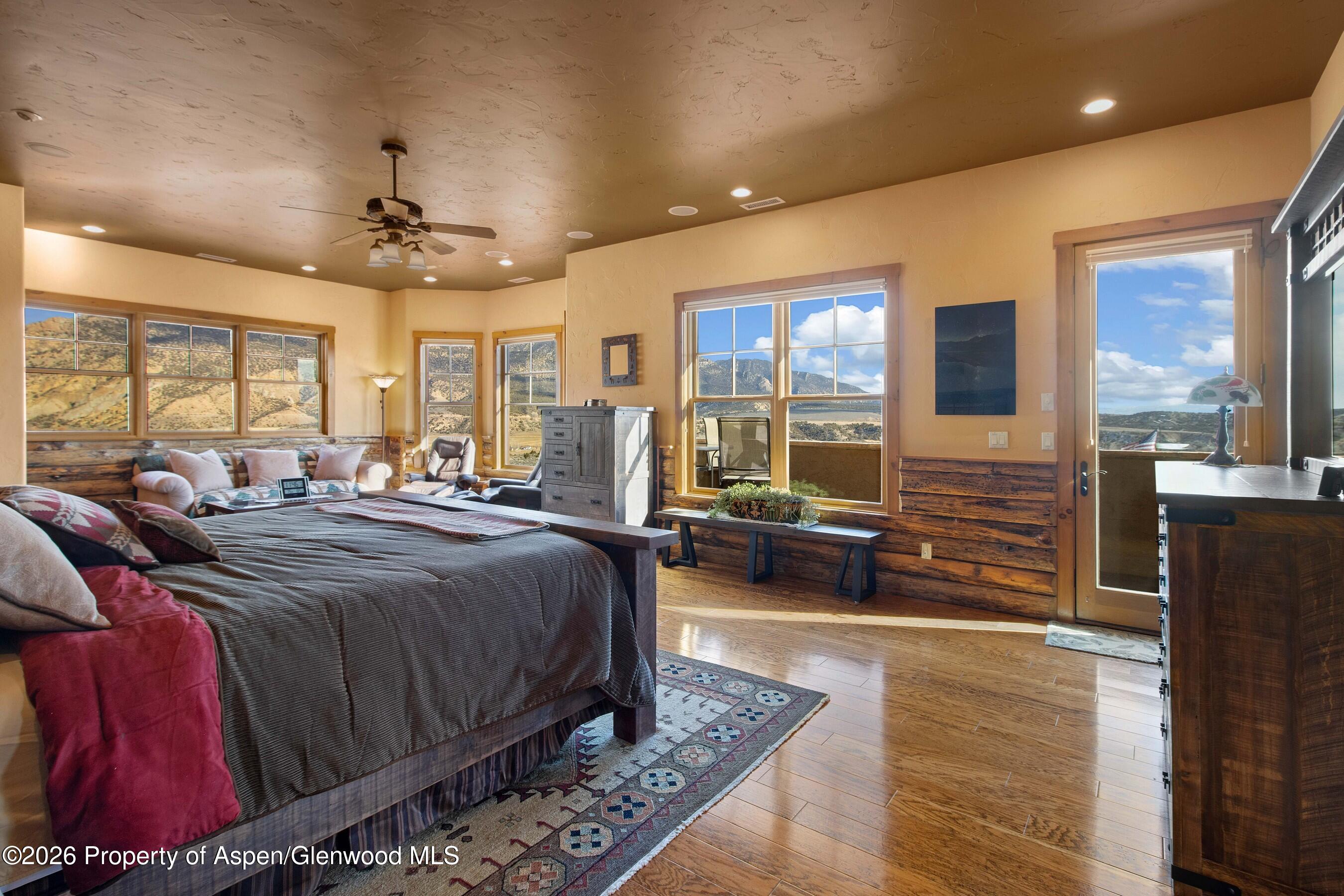 966 Mesa Drive Rifle, CO 81650 - Photo 28 of 54 a spacious bedroom with a bed a couch and large window