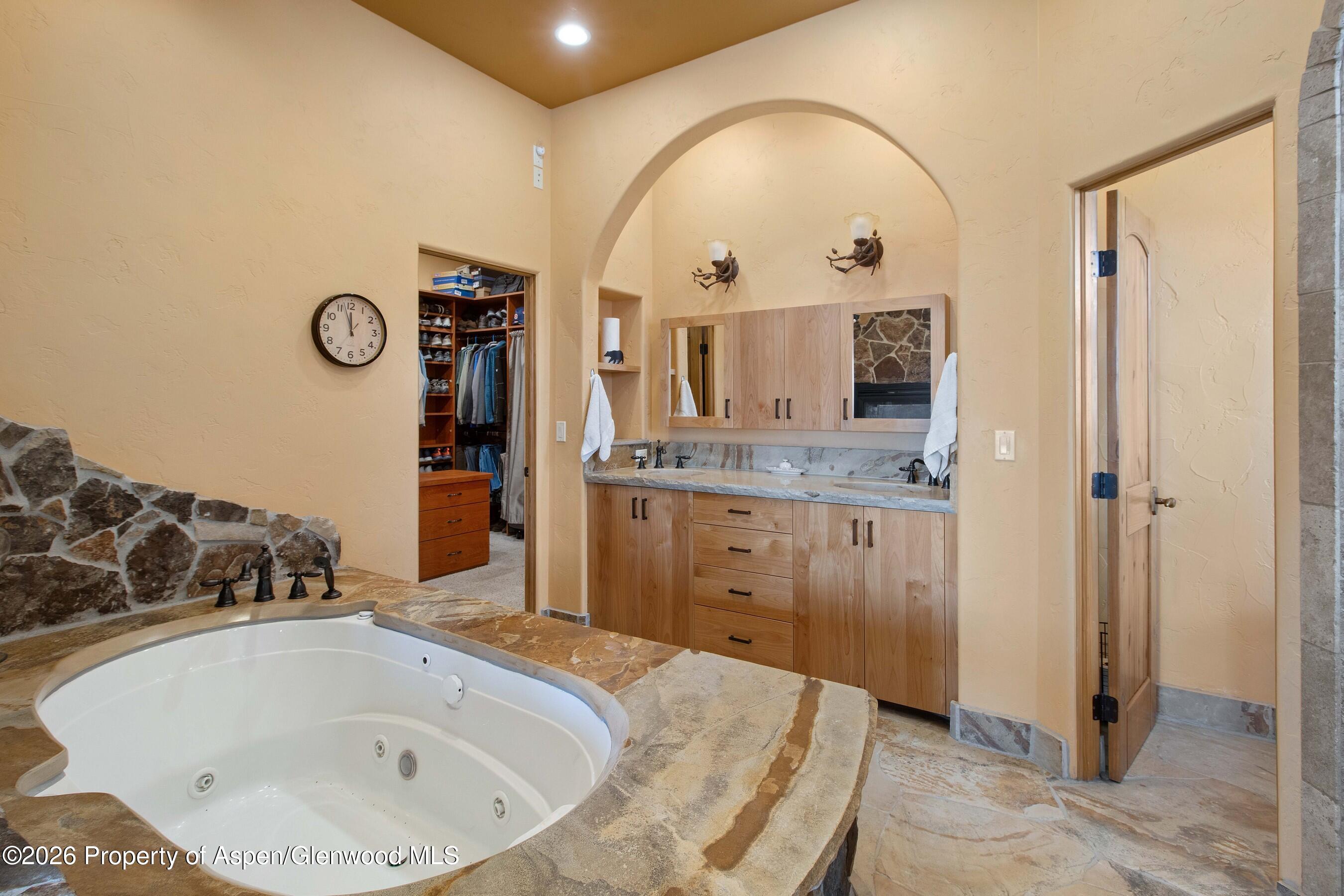 966 Mesa Drive Rifle, CO 81650 - Photo 31 of 54 a bathroom with a tub sink and mirror