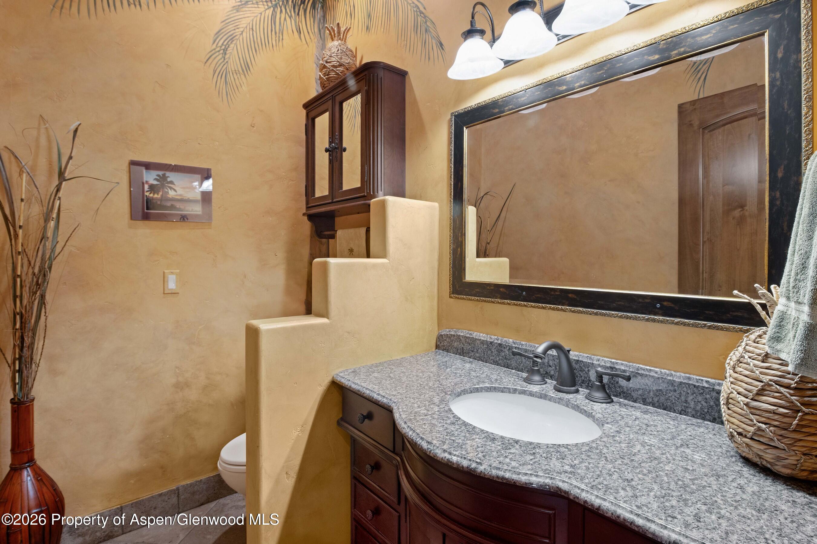 966 Mesa Drive Rifle, CO 81650 - Photo 36 of 54 a bathroom with a granite countertop sink and a mirror