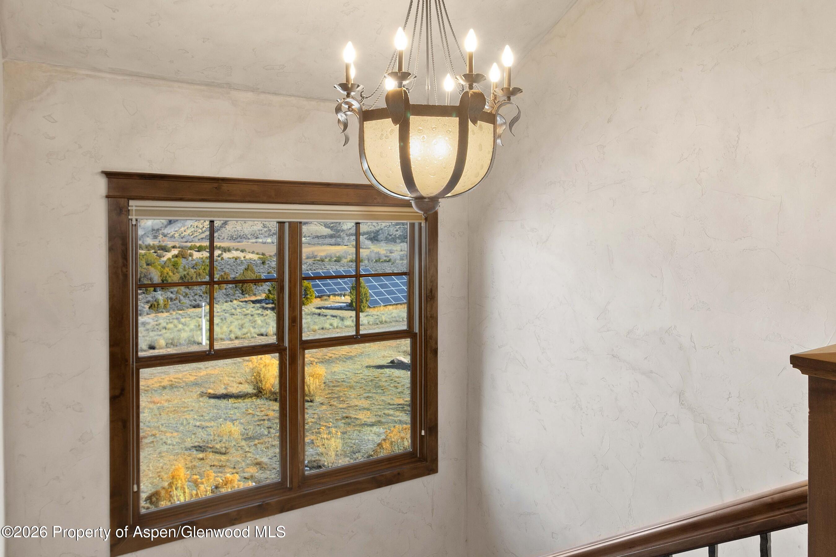 966 Mesa Drive Rifle, CO 81650 - Photo 37 of 54 a very nice looking room with a large window and chandelier