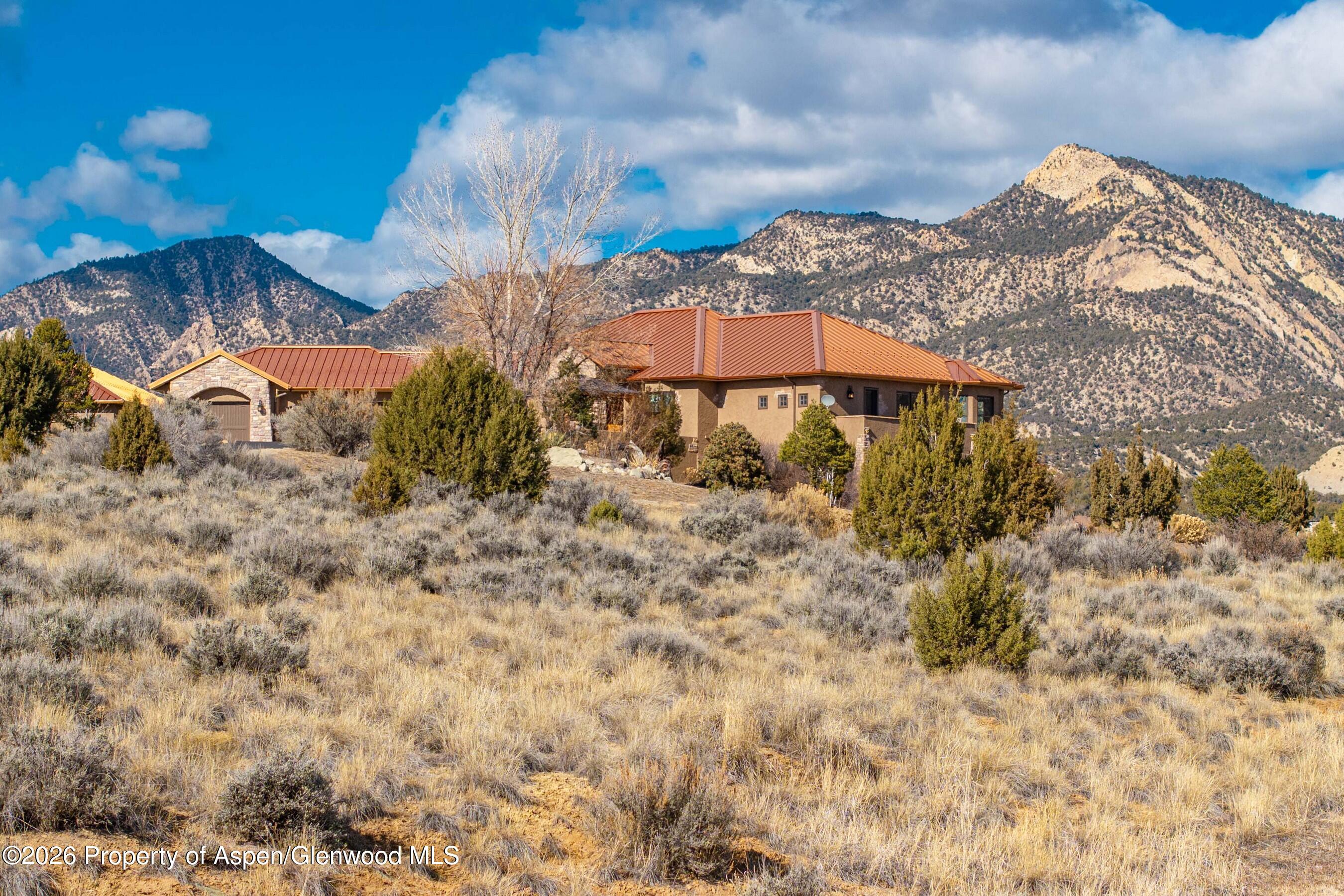 966 Mesa Drive Rifle, CO 81650 - Photo 51 of 54 a view of a backyard with plants and a lake view