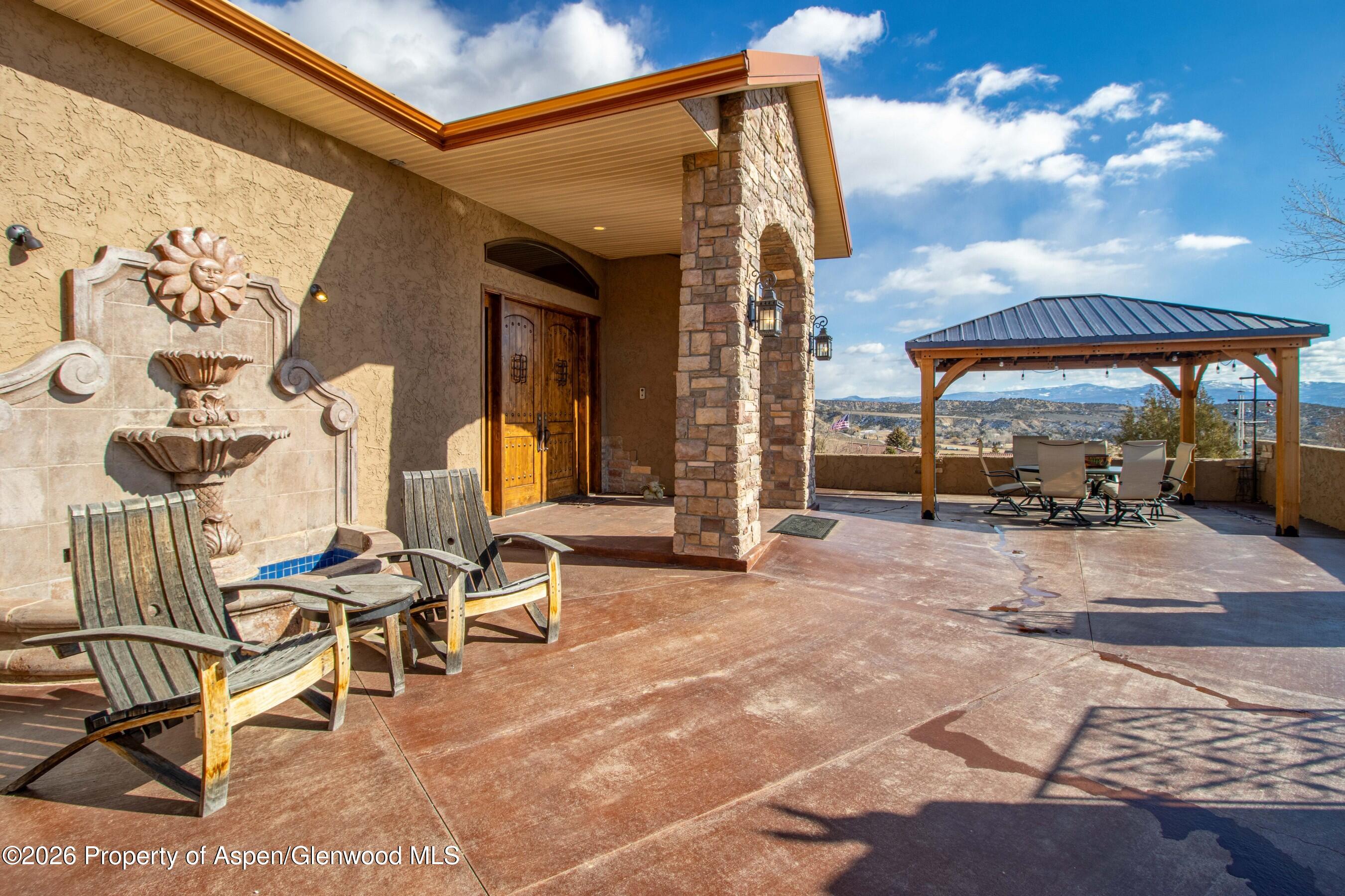 966 Mesa Drive Rifle, CO 81650 - Photo 8 of 54 a view of a patio with a table and chairs
