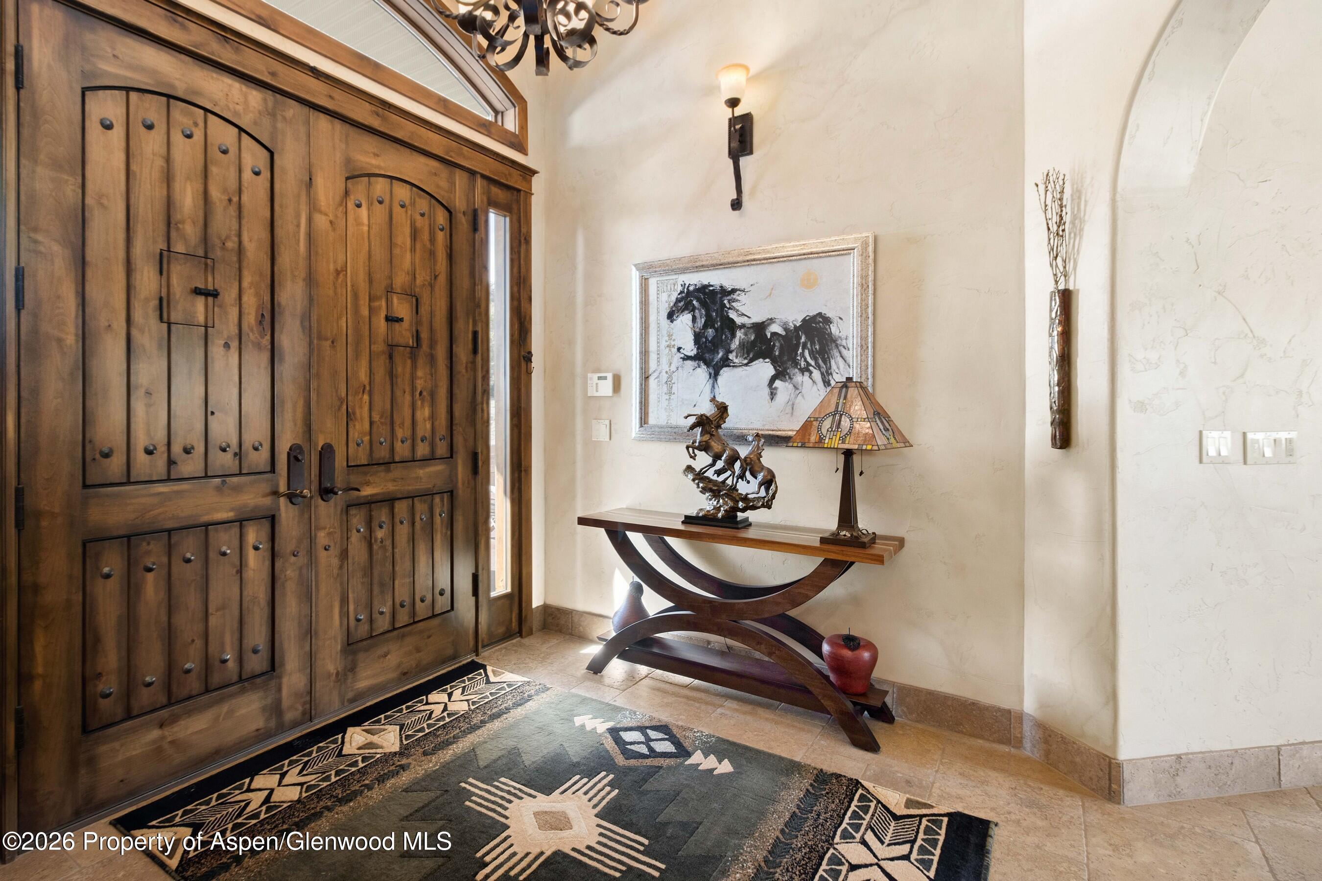 966 Mesa Drive Rifle, CO 81650 - Photo 9 of 54 a view of a hallway with wooden floor and furniture