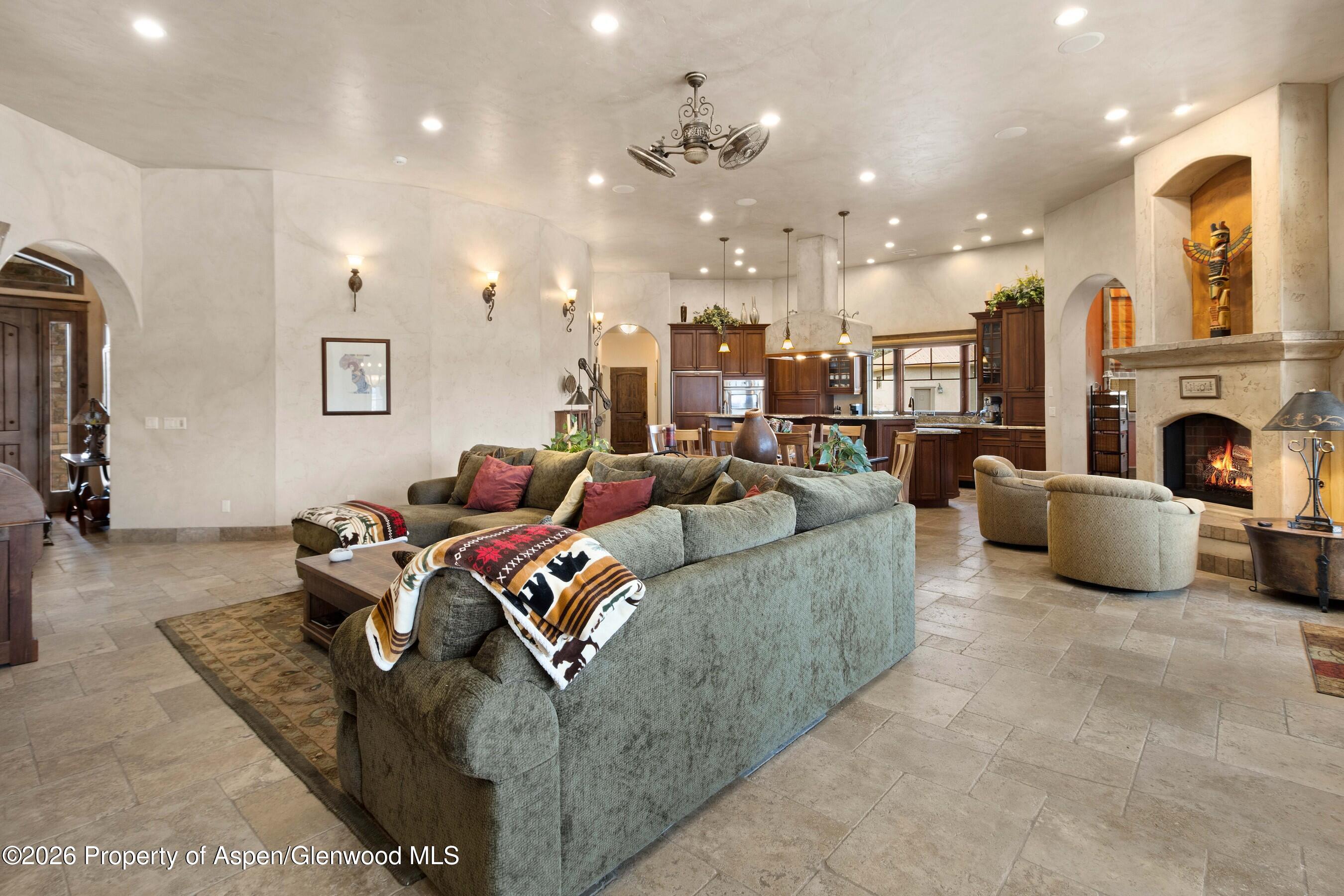 966 Mesa Drive Rifle, CO 81650 - Photo 10 of 54 a living room with furniture kitchen view and a chandelier