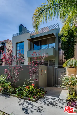 a front view of a house with a yard and fountain