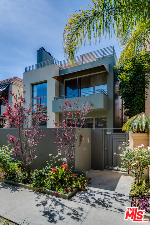 a front view of a house with a yard and fountain