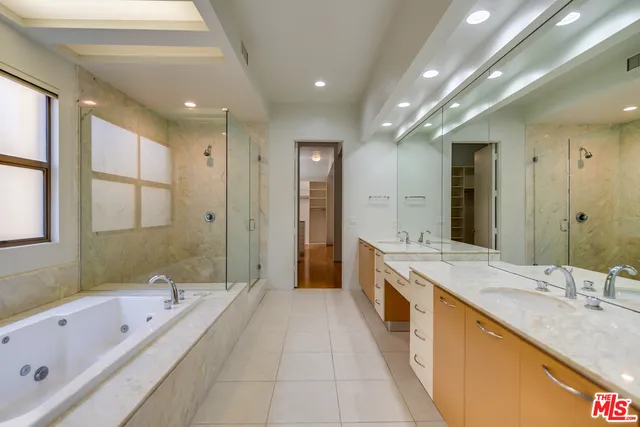 a spacious bathroom with a granite countertop tub sink shower and mirror