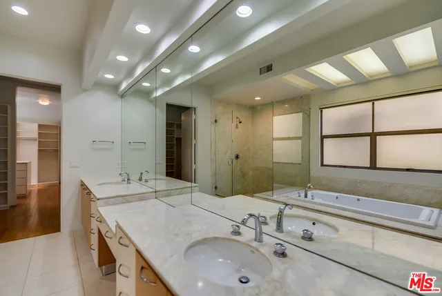 a bathroom with a double vanity sink and a mirror