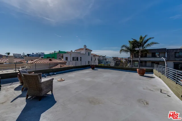 a reading room with furniture and a potted plant