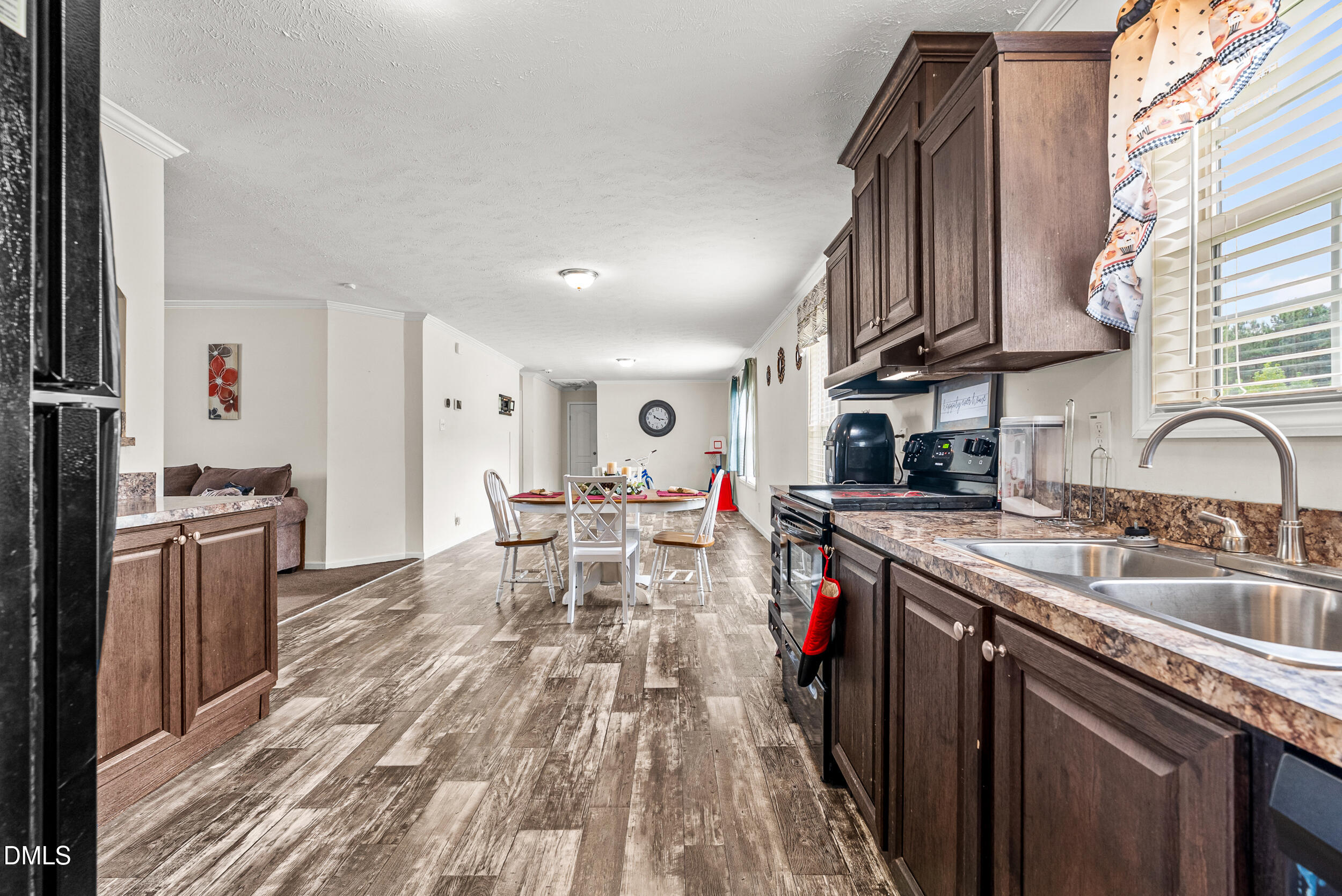 883 Low Ground Road Enfield, NC 27823 - Photo 10 of 26 a kitchen with stainless steel appliances granite countertop a sink stove and cabinets