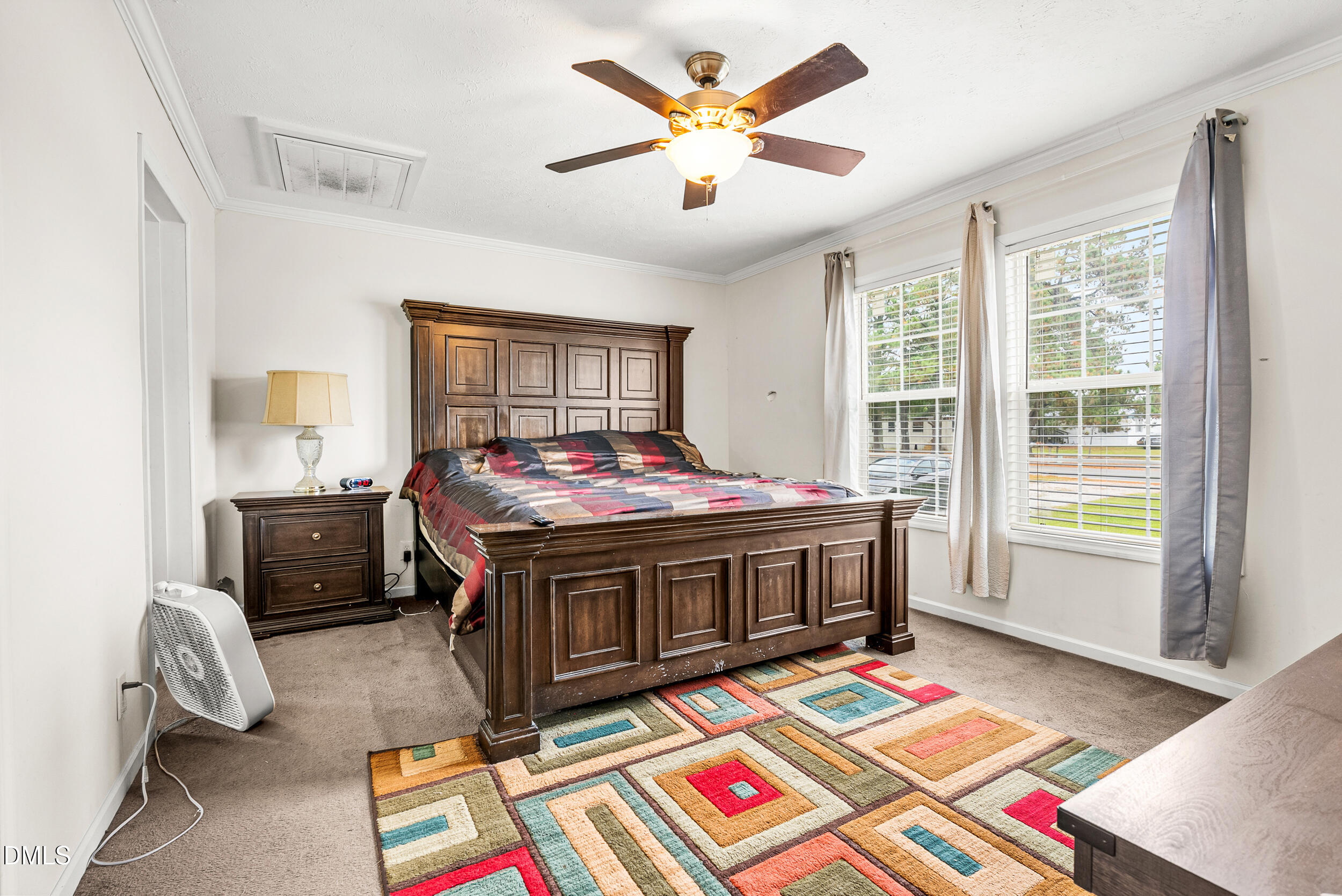 883 Low Ground Road Enfield, NC 27823 - Photo 13 of 26 a living room with a bed and a table