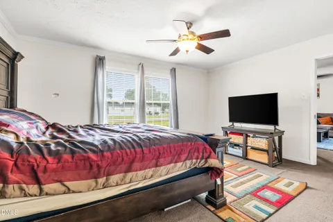 a living room with a bed and a table