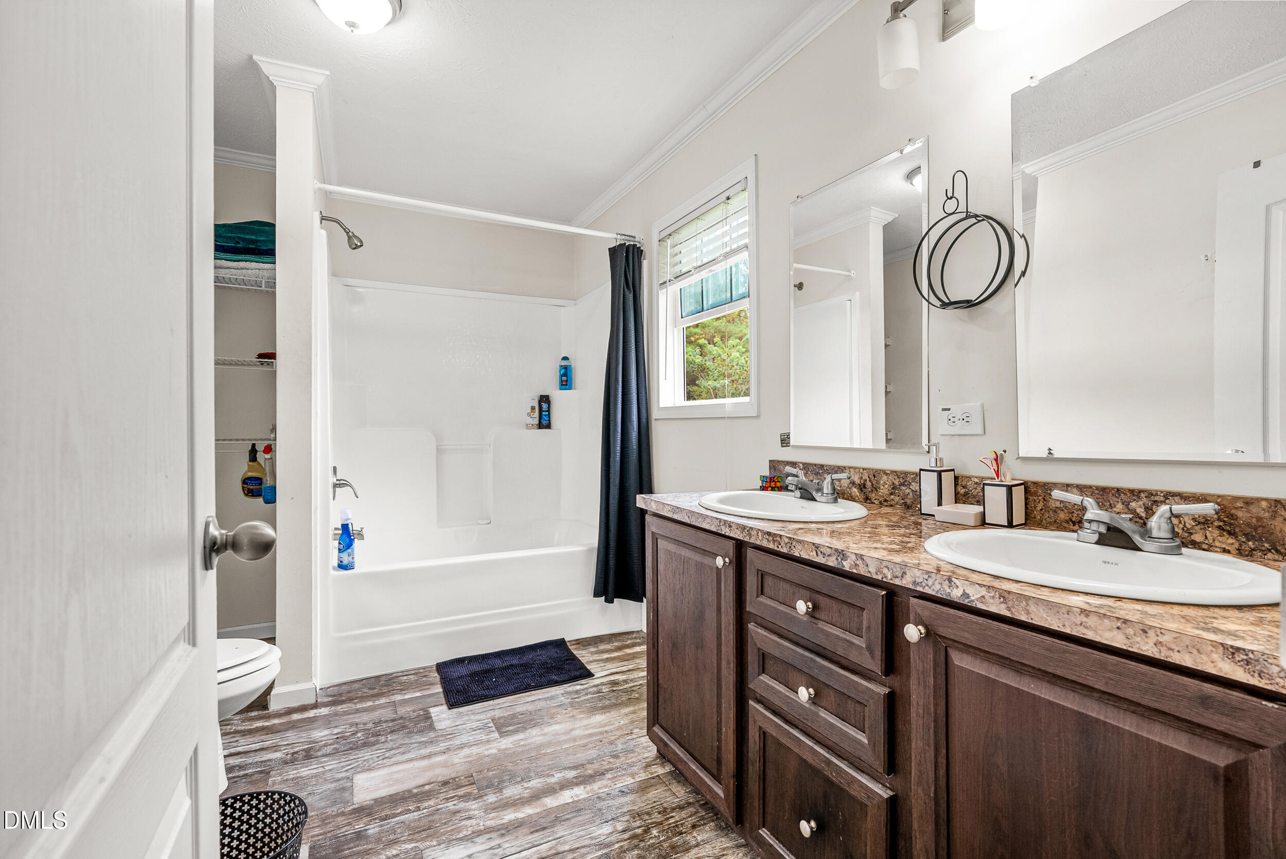 883 Low Ground Road Enfield, NC 27823 - Photo 15 of 26 a spacious bathroom with a granite countertop sink mirror and a shower