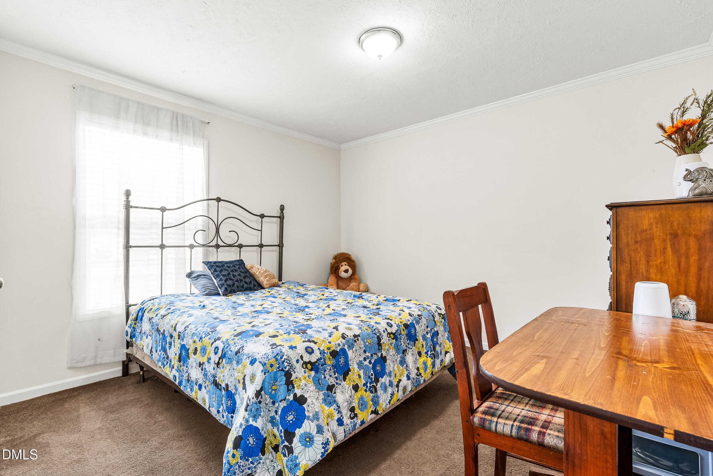 883 Low Ground Road Enfield, NC 27823 - Photo 16 of 26 a bedroom with a bed and a table in it