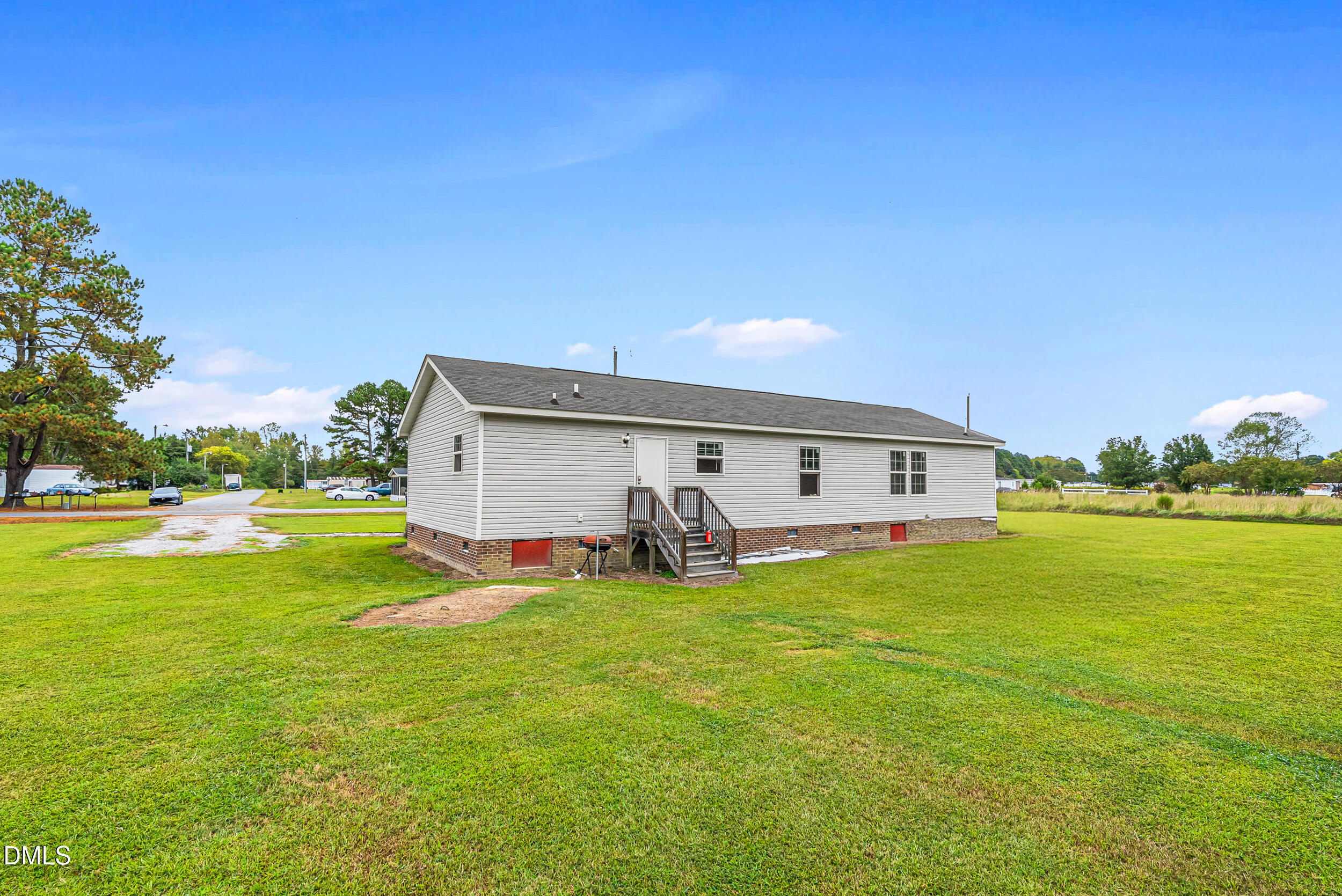 883 Low Ground Road Enfield, NC 27823 - Photo 19 of 26 a big white house with a big yard and large trees