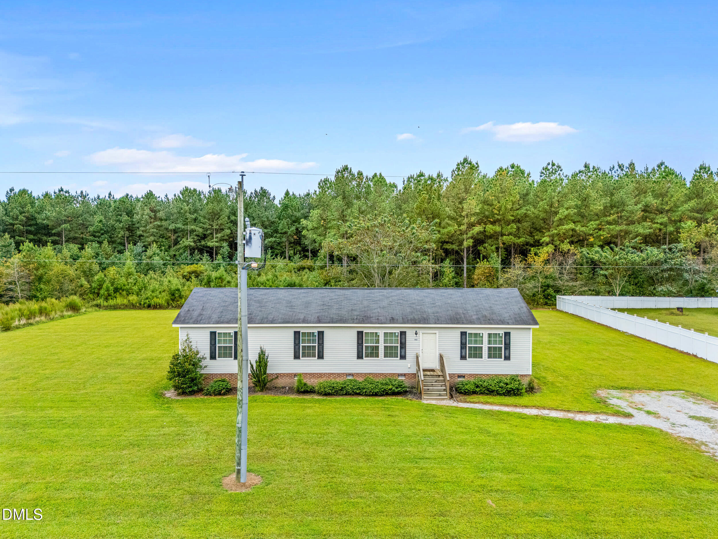 883 Low Ground Road Enfield, NC 27823 - Photo 20 of 26 a view of a house with a big yard and large trees