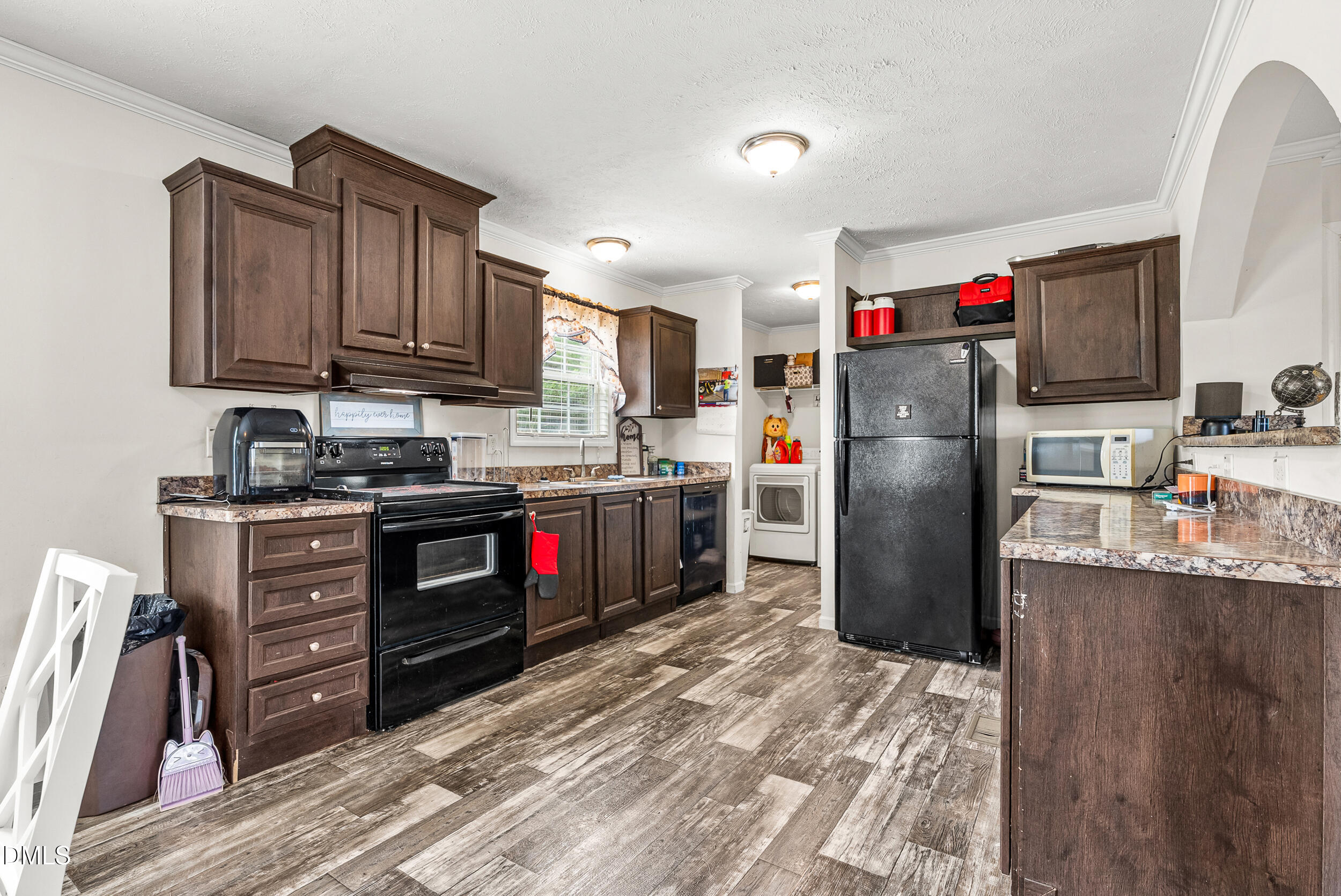 883 Low Ground Road Enfield, NC 27823 - Photo 8 of 26 a kitchen with stainless steel appliances granite countertop a refrigerator stove and a sink