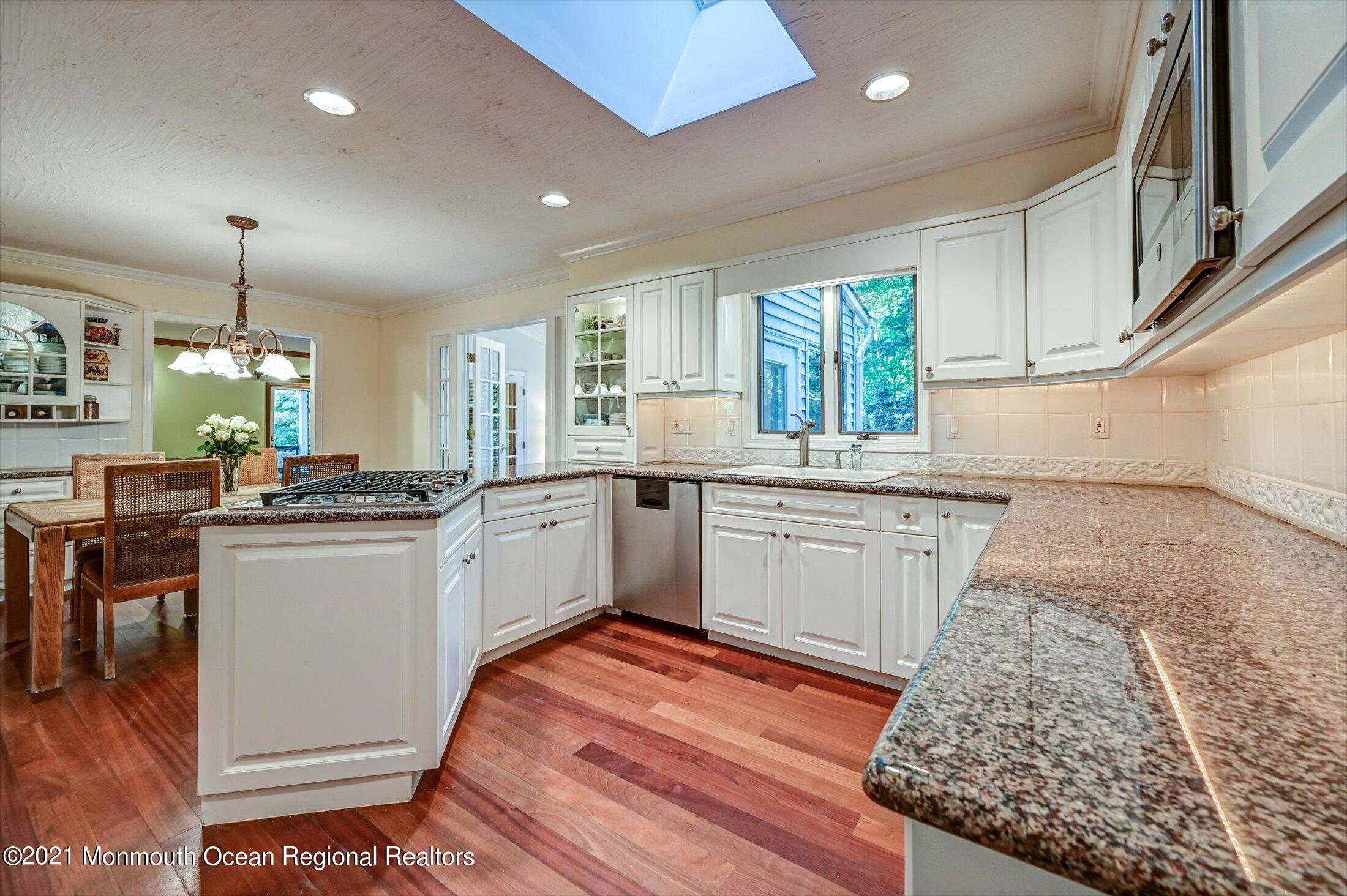10 Crowfield Lane Holmdel, NJ 07733 - Photo 15 of 52 a kitchen with a sink window and cabinets