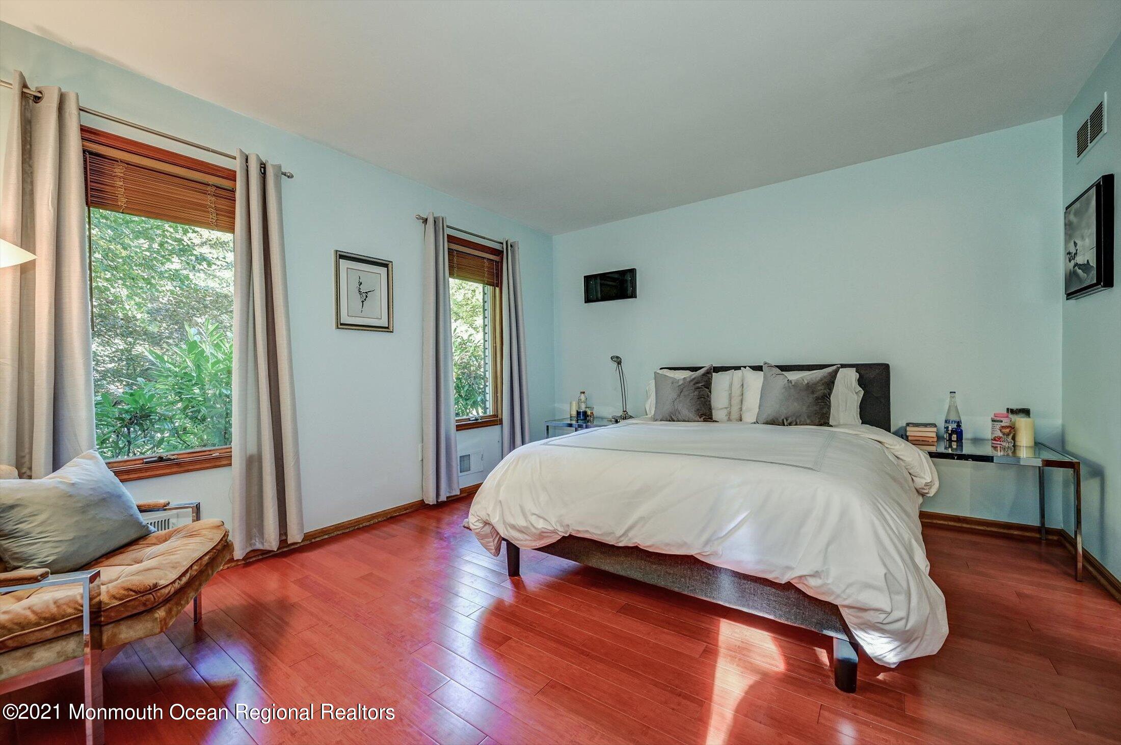 10 Crowfield Lane Holmdel, NJ 07733 - Photo 18 of 52 a bedroom with a bed and wooden floor