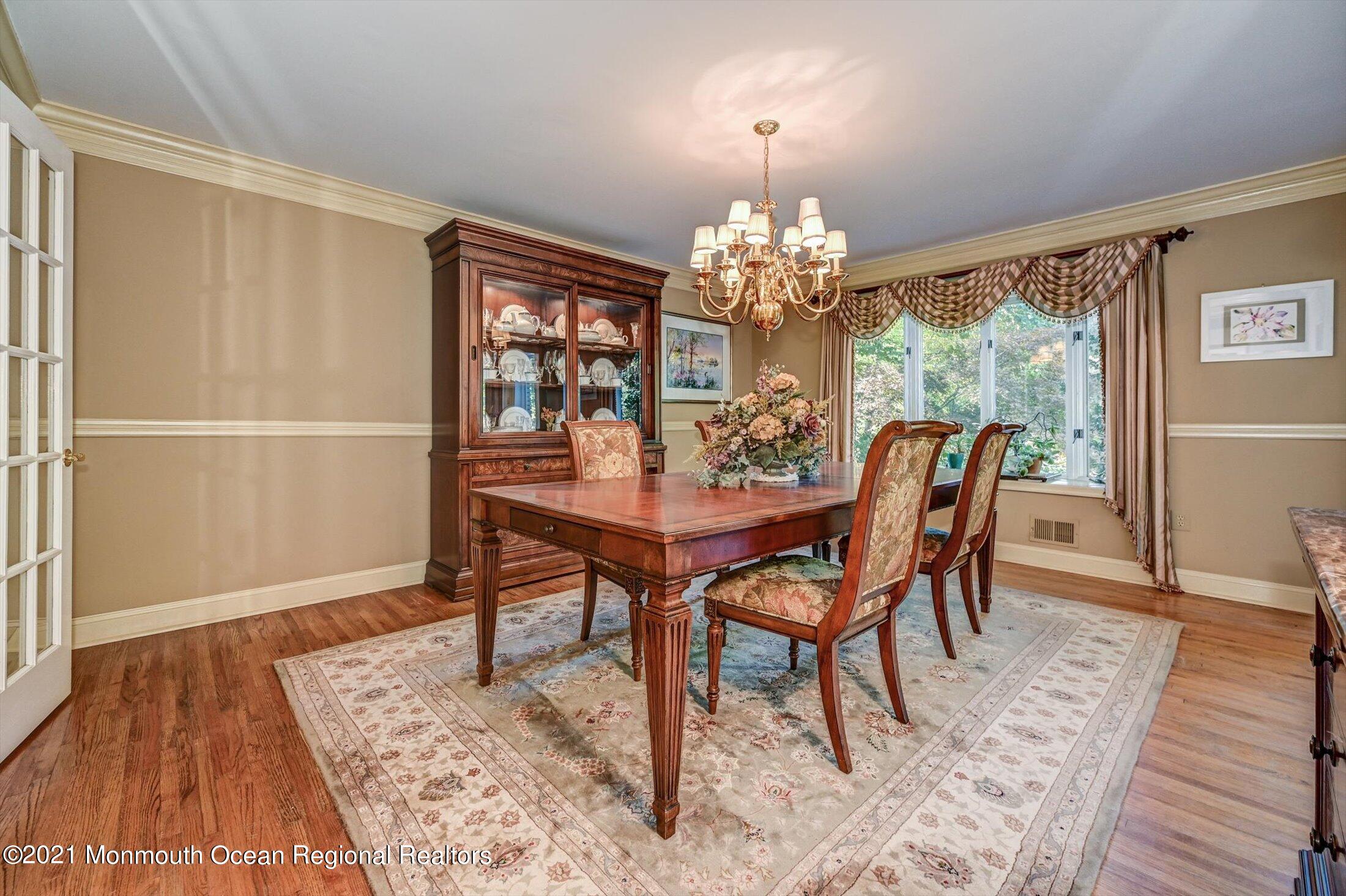 10 Crowfield Lane Holmdel, NJ 07733 - Photo 4 of 52 a view of a dining room with furniture wooden floor and chandelier