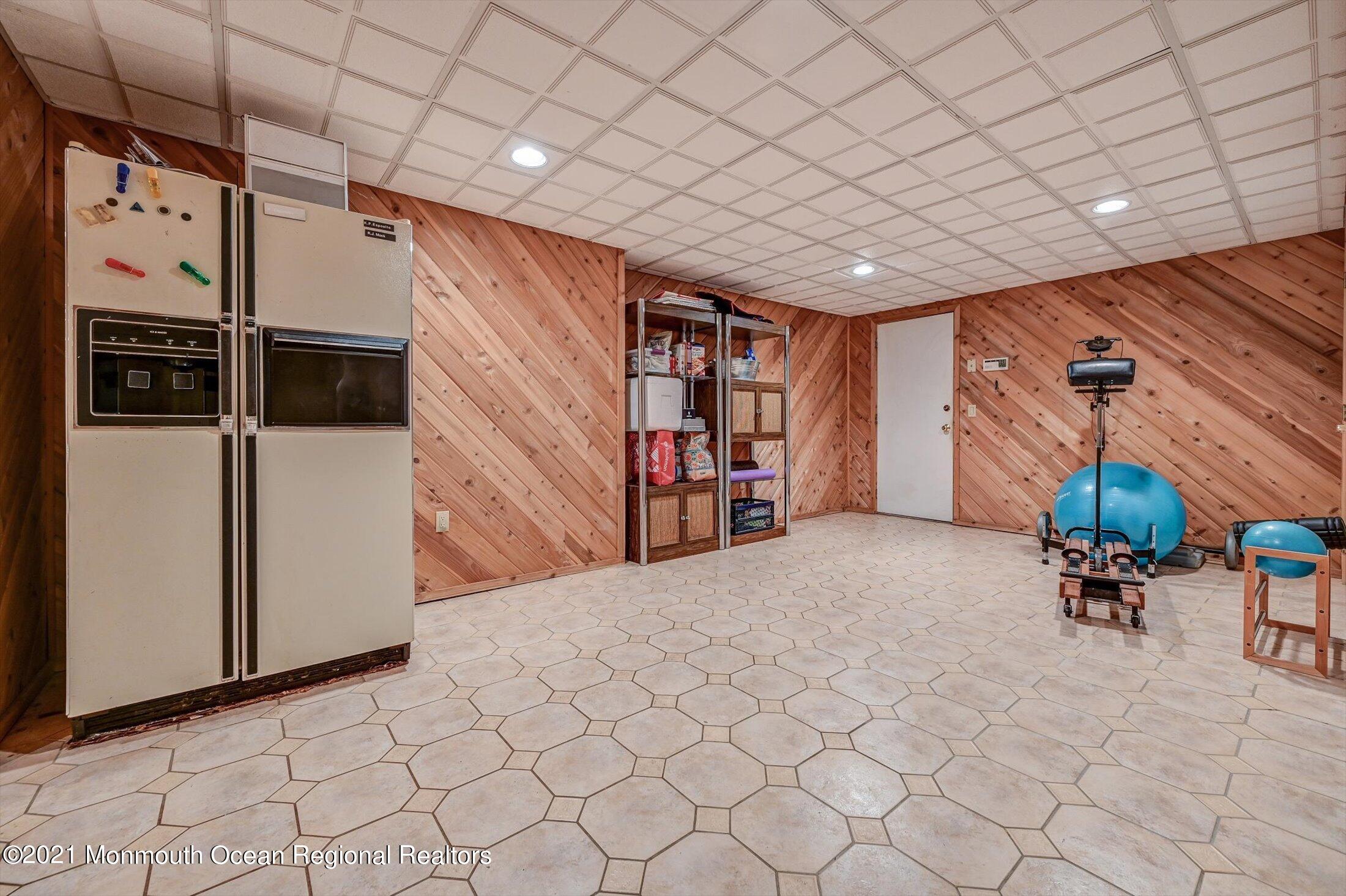 10 Crowfield Lane Holmdel, NJ 07733 - Photo 33 of 52 a living room with furniture and a book shelf