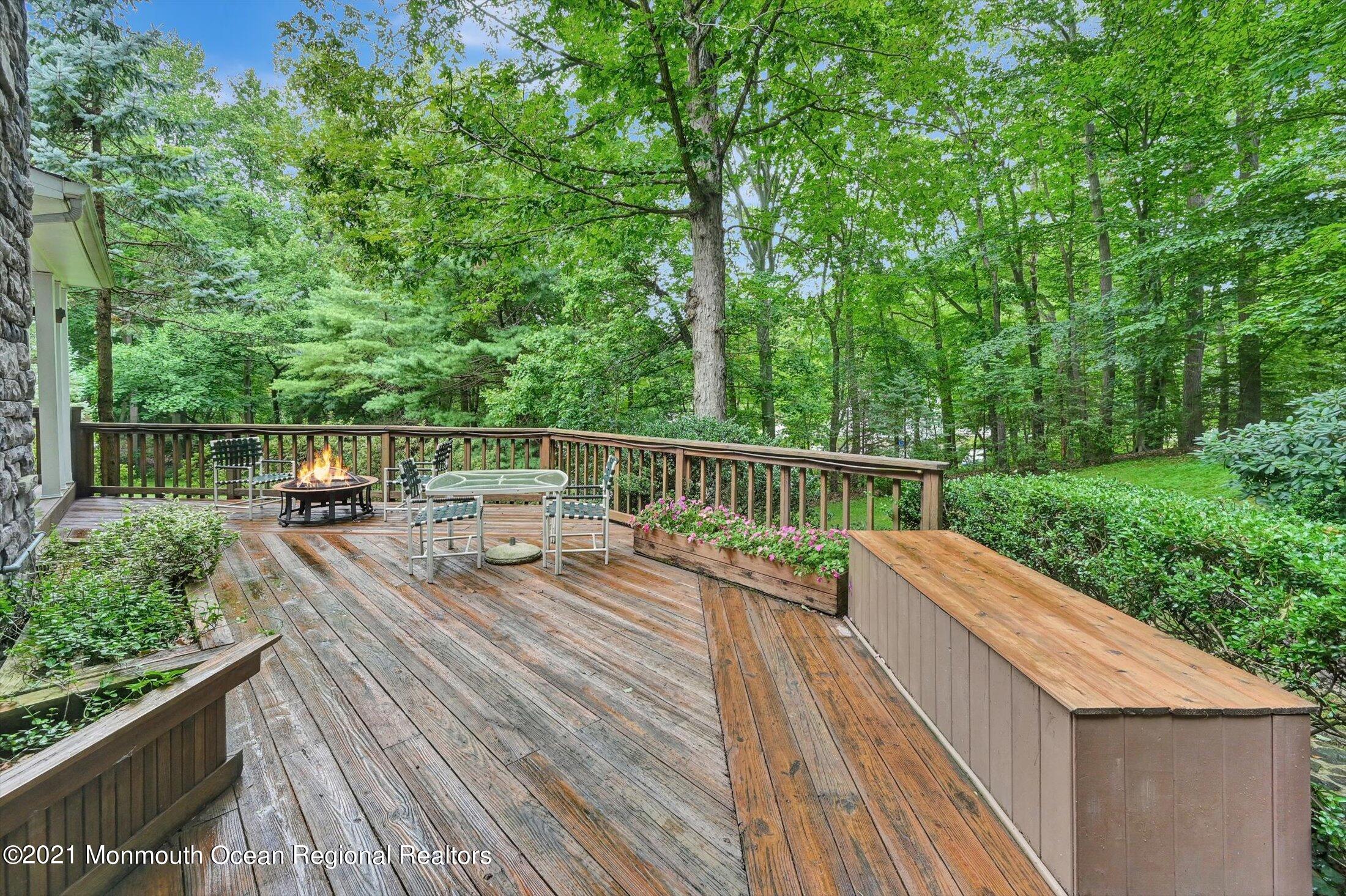 10 Crowfield Lane Holmdel, NJ 07733 - Photo 38 of 52 a view from deck with a table and chairs