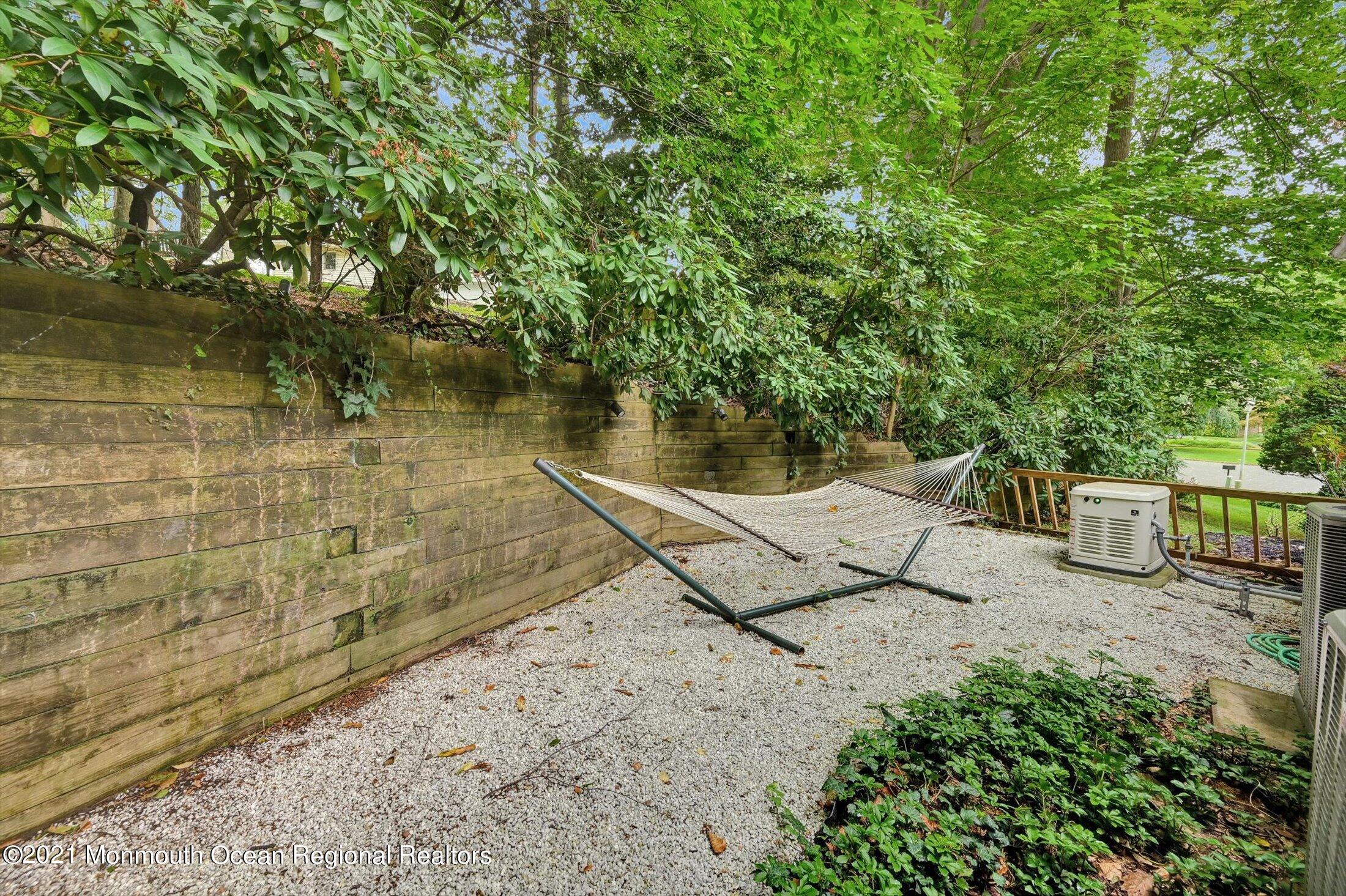 10 Crowfield Lane Holmdel, NJ 07733 - Photo 43 of 52 a view of a house with a small yard and large tree