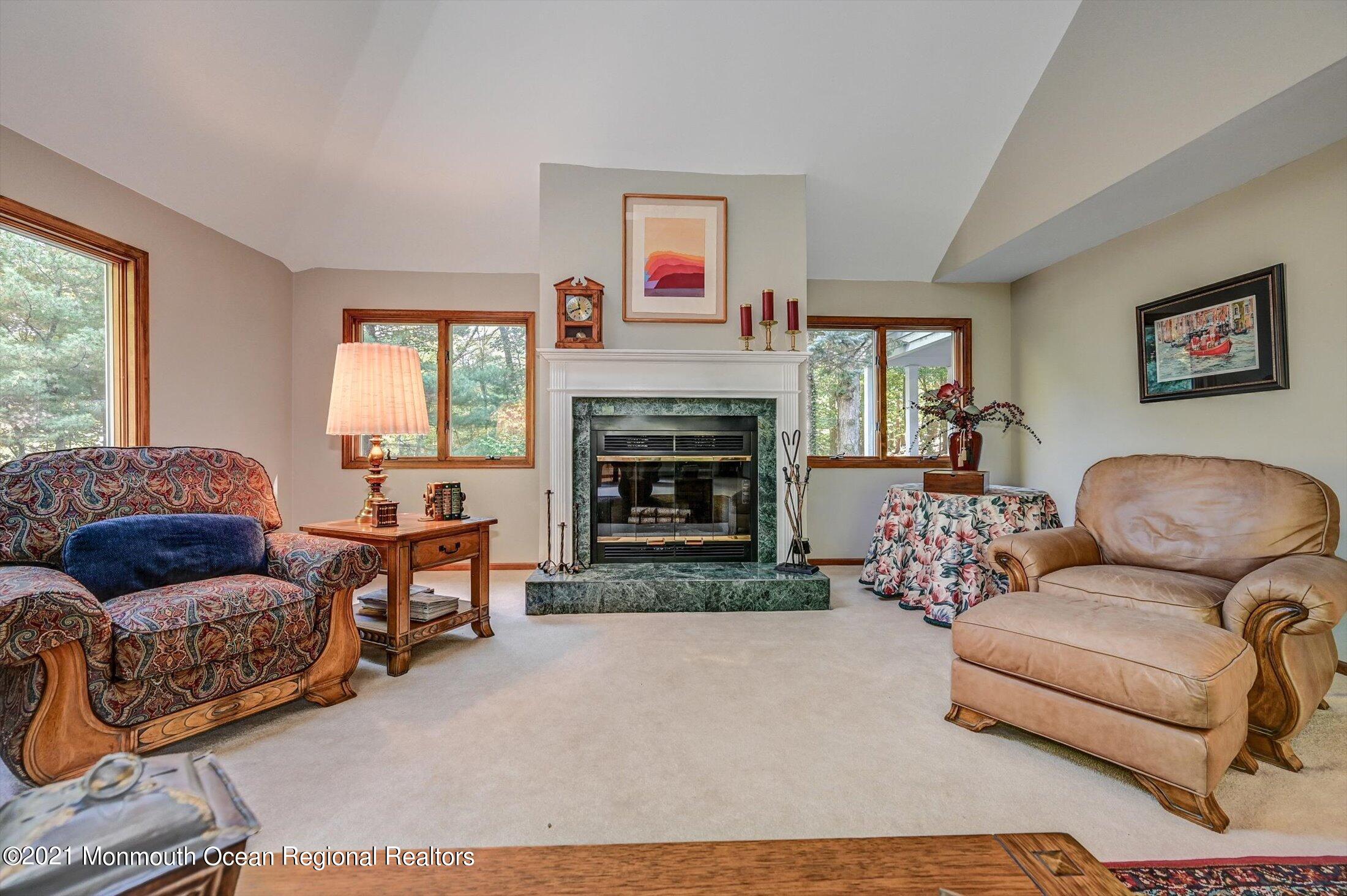 10 Crowfield Lane Holmdel, NJ 07733 - Photo 6 of 52 a living room with furniture fireplace and window