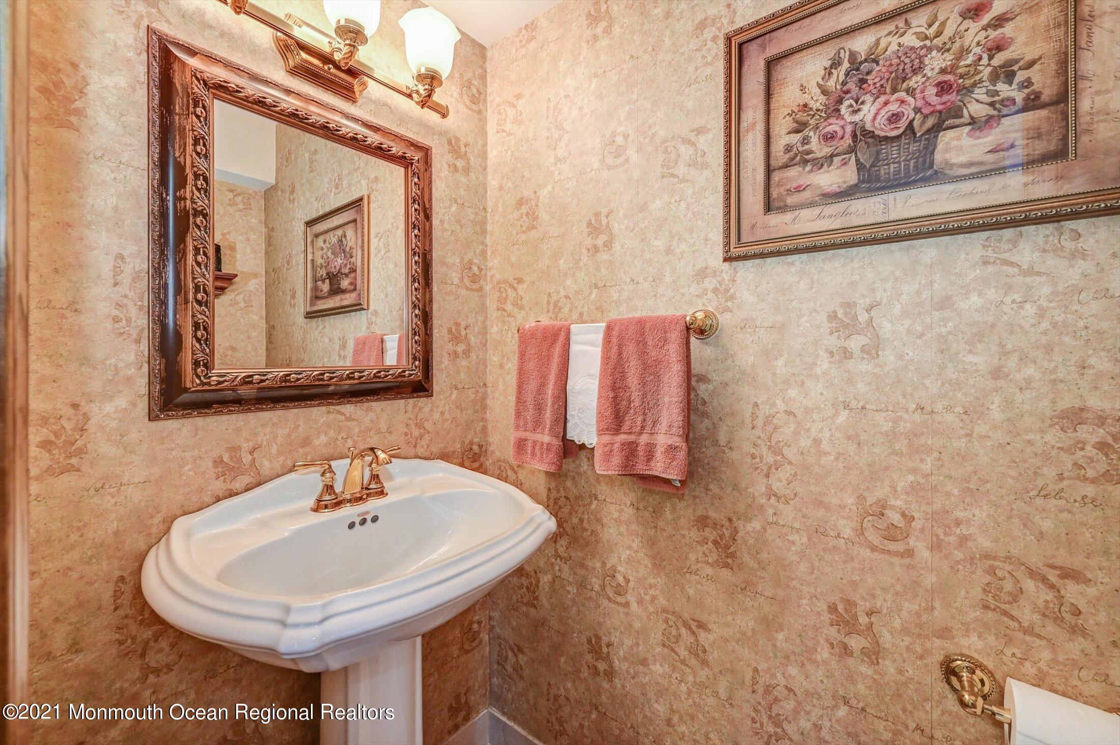 10 Crowfield Lane Holmdel, NJ 07733 - Photo 9 of 52 a bathroom with a sink and a mirror