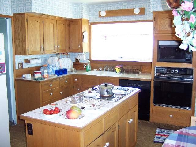 3421 Scoon Road Sunnyside, WA 98944 - Photo 4 of 7 a kitchen with a stove a sink and a microwave