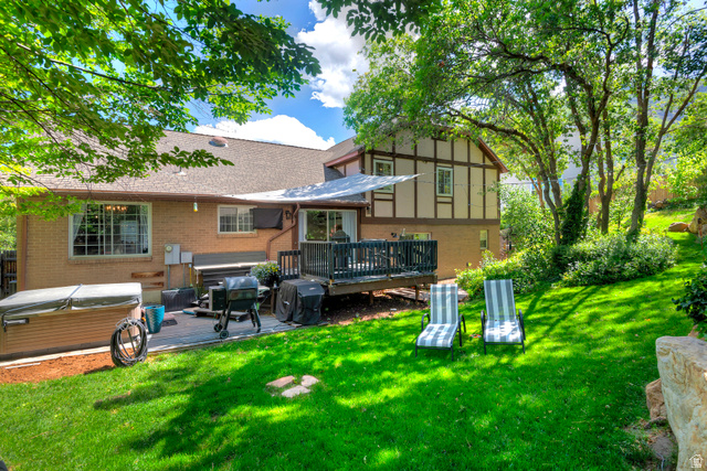 3310 Creek Road Salt Lake City, UT 84121 - Photo 2 of 49 Expansive backyard featuring a manicured lawn, multi-level deck, and mature trees