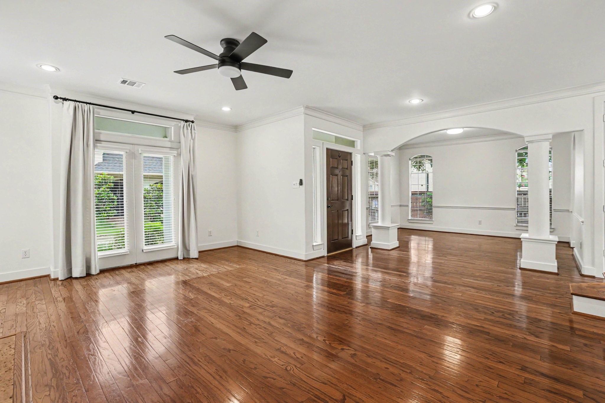 1470 Springrock Lane, Unit 6 Houston, TX 77055 - Photo 6 of 31 This spacious living area features hardwood floors, a cozy fireplace, high ceilings, crown molding, and large windows that fill the room with natural light.