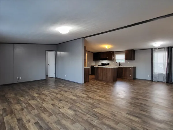 a view of a kitchen with a sink and a fireplace