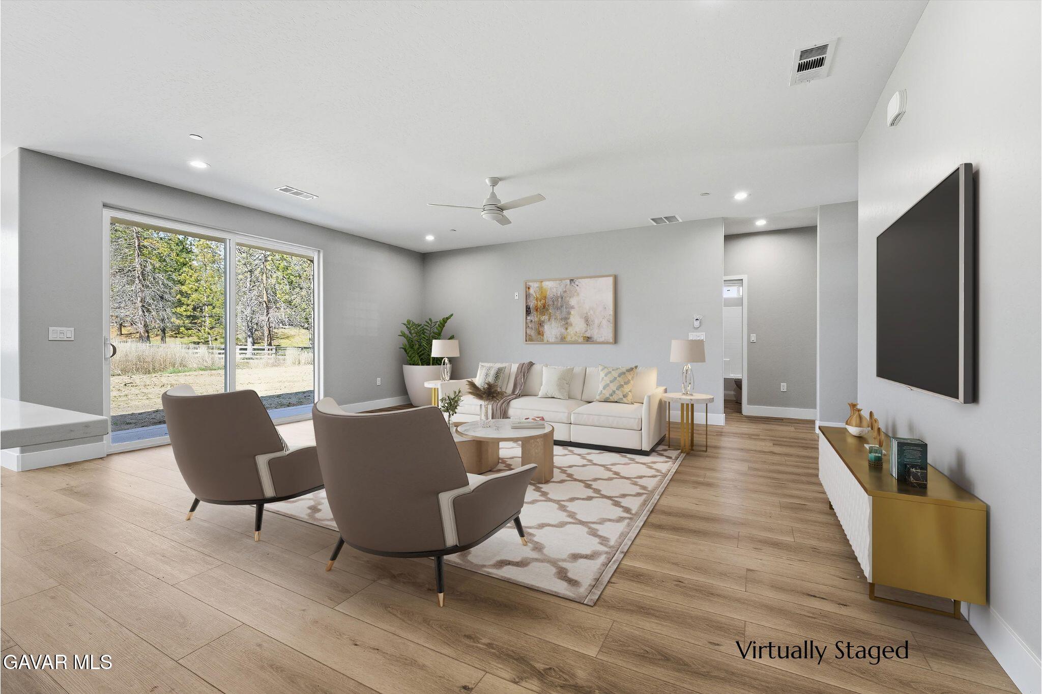22613 Royal Place Tehachapi, CA 93561 - Photo 5 of 28 a living room with furniture and a flat screen tv