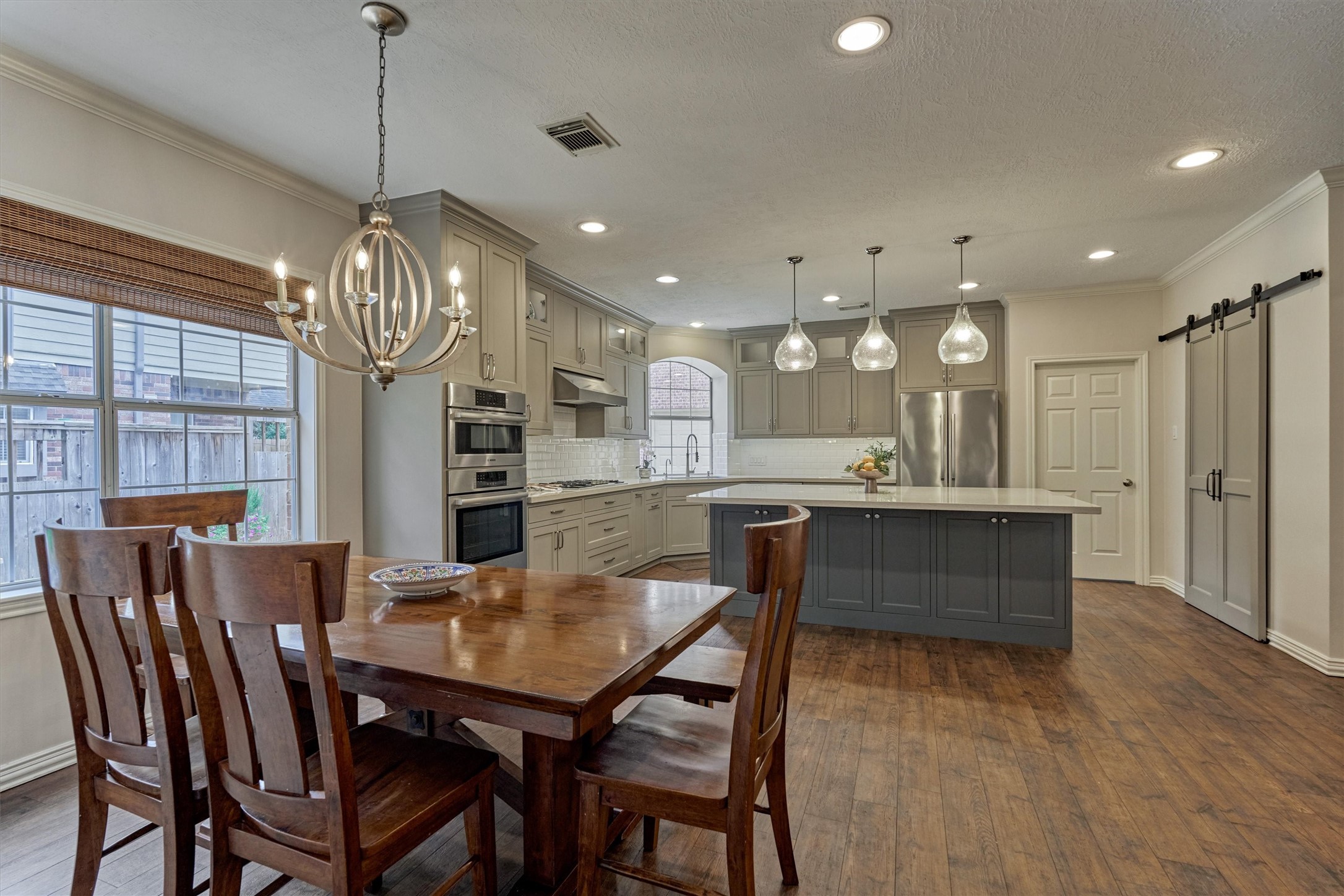 16707 Avenfield Road Tomball, TX 77377 - Photo 9 of 50 a dining area with furniture a chandelier and kitchen view