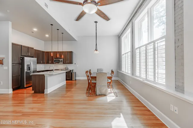 a large white kitchen with lots of counter space a sink appliances and cabinets