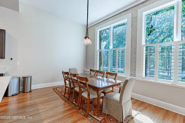 a dining room with furniture and wooden floor