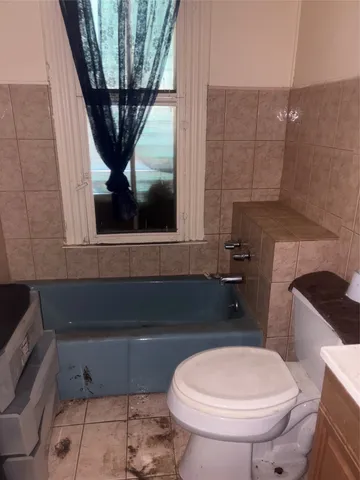 a bathroom with a toilet a sink and bathtub