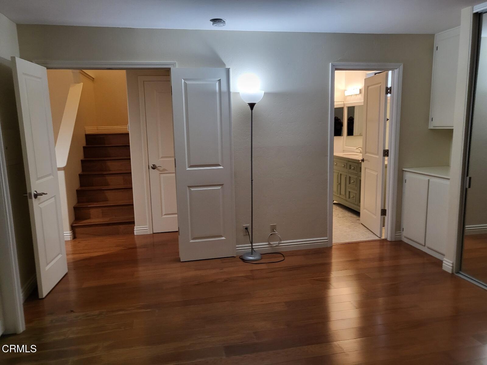 3701 Via Pacifica Walk Oxnard, CA 93035 - Photo 11 of 49 an empty room with wooden floor and windows