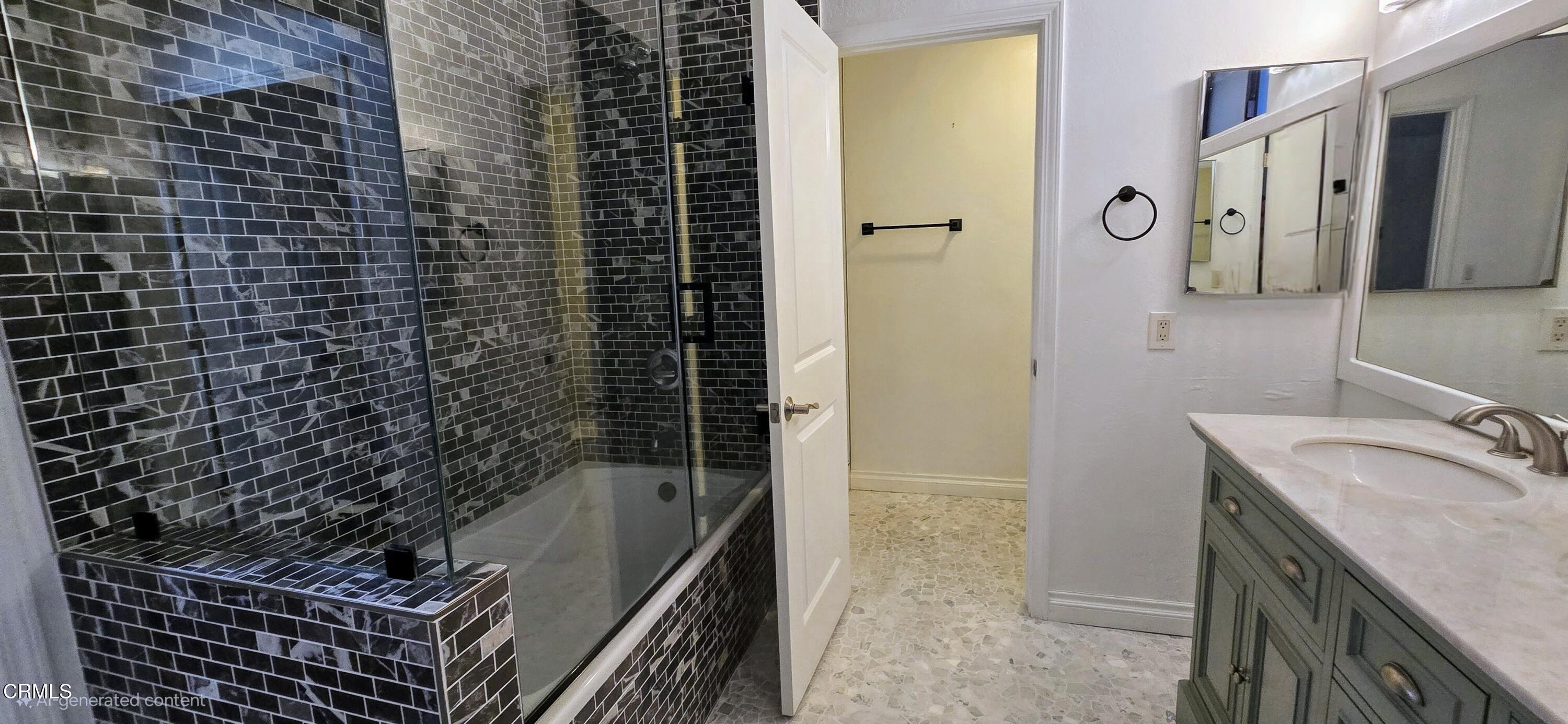 3701 Via Pacifica Walk Oxnard, CA 93035 - Photo 13 of 49 a bathroom with a granite countertop sink a mirror and shower